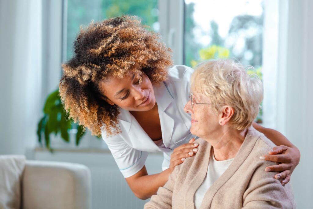 nurse engaging in conversation with nursing home resident