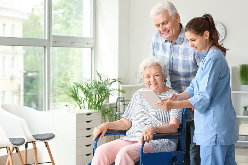 Elderly couple with nursing home employee.